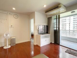 Bright living room with wooden flooring and large balcony view