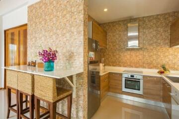 Modern kitchen with bar seating and stainless steel appliances