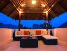 Cozy outdoor living area with a sectional couch and ambient lighting