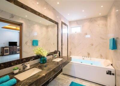 Modern bathroom with marble walls and dual sinks