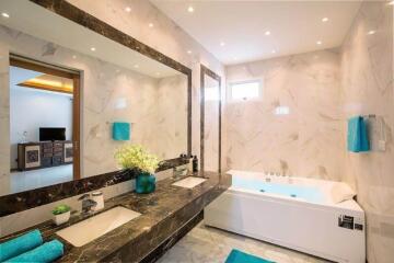 Modern bathroom with marble walls and dual sinks
