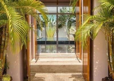 Entrance with open double doors and tropical plants
