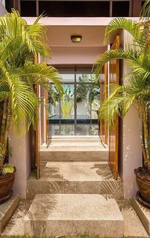 Entrance with open double doors and tropical plants