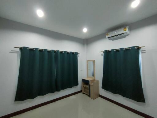 Bedroom with dark curtains and air conditioning
