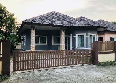 Exterior of a modern single-story house with gate