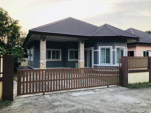 Exterior of a modern single-story house with gate