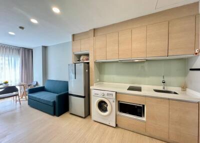 Modern kitchen with built-in appliances and adjacent living area
