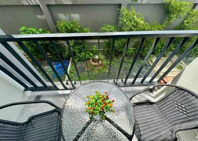 View from balcony with garden and outdoor seating