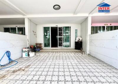 Front view of a residential property with a tiled floor and double glass doors