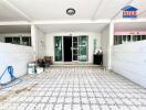 Front view of a residential property with a tiled floor and double glass doors