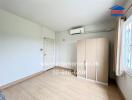 Bedroom with wooden wardrobe and air conditioning unit