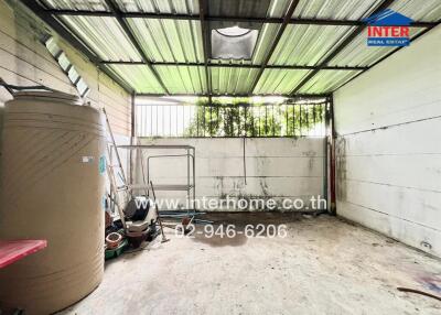 Outdoor storage space with a water tank and miscellaneous items