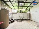 Outdoor storage space with a water tank and miscellaneous items