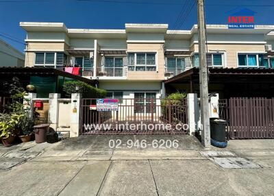 Two-story residential building with gated entrance