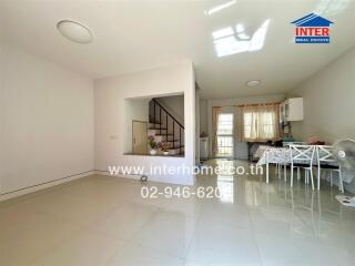 Modern living space with staircase and dining area