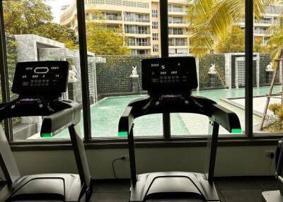 Gym with treadmills and pool view