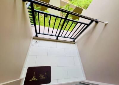 Small balcony area with railing and doormat