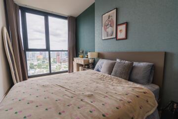 Cozy bedroom with a large window and city view