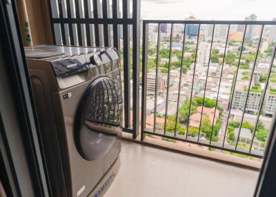 Balcony with washing machine and city view