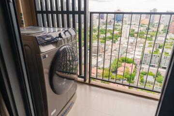 Balcony with washing machine and city view