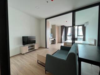 Modern living room with a view into the bedroom