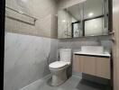 Modern bathroom with subway tile walls, floating vanity, and large mirror