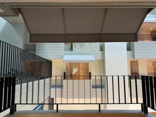 View of modern building corridors and railings from an outdoor balcony area