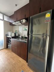 Modern kitchen with dark wood cabinets and stainless steel appliances