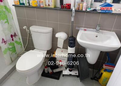 Small bathroom with shower, toilet, and sink