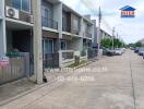 Street view of townhouses with balconies and parked cars