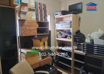 Home office with multiple storage shelves and office equipment