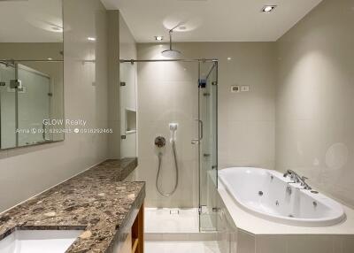 Modern bathroom with a glass-enclosed shower and a separate bathtub