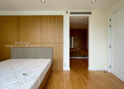 Spacious bedroom with wooden flooring and built-in closet