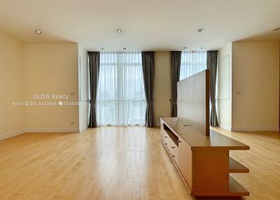 Spacious main living area with large windows and wooden flooring