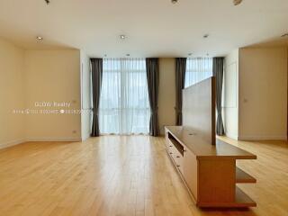 Spacious main living area with large windows and wooden flooring