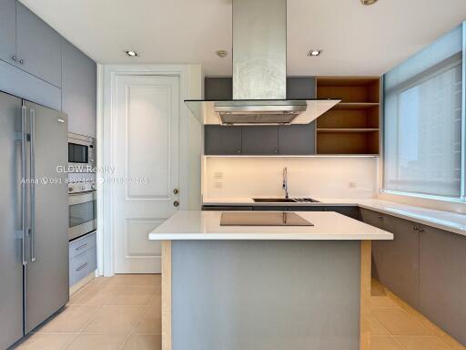 Modern kitchen with island, built-in appliances, and ample storage