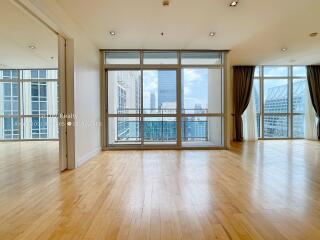 Spacious living room with large windows and city view
