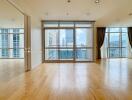 Spacious living room with large windows and city view