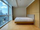 Spacious bedroom with large windows and city view