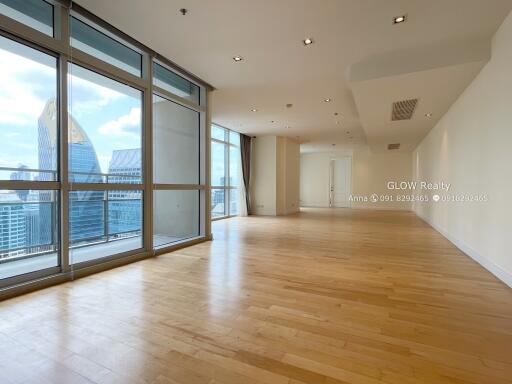 Spacious living room with large windows and city view