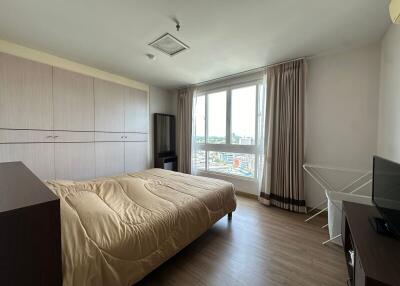Bedroom with large window and ample lighting