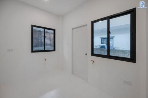 Minimalist laundry room with windows and utility hookups