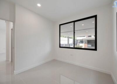 Bright empty bedroom with large windows