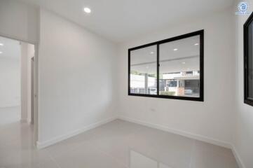 Bright empty bedroom with large windows