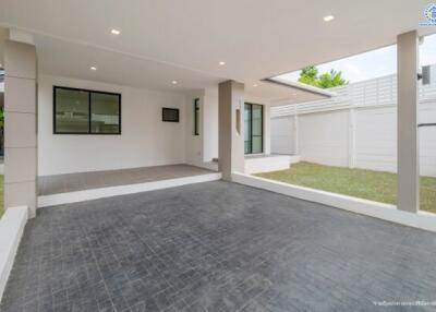 modern house exterior with a patio and lawn