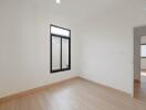 Bedroom with wooden floor and large window