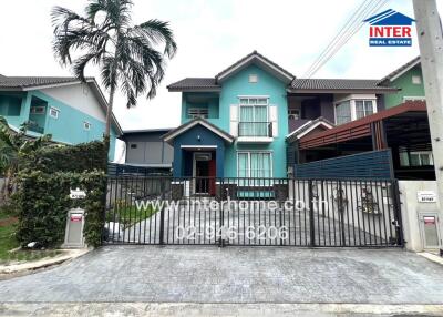 Modern two-story house with a blue and teal color scheme