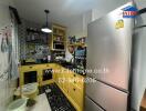 Compact fully equipped kitchen with yellow cabinets