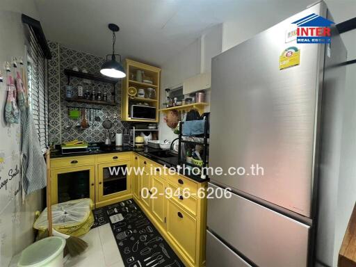 Compact fully equipped kitchen with yellow cabinets