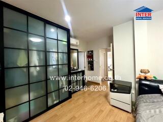 Bedroom with sliding door closet and wooden flooring